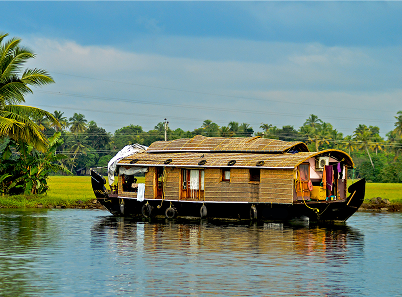 A photo of a House boat on a calm lake with topical plains in the distance